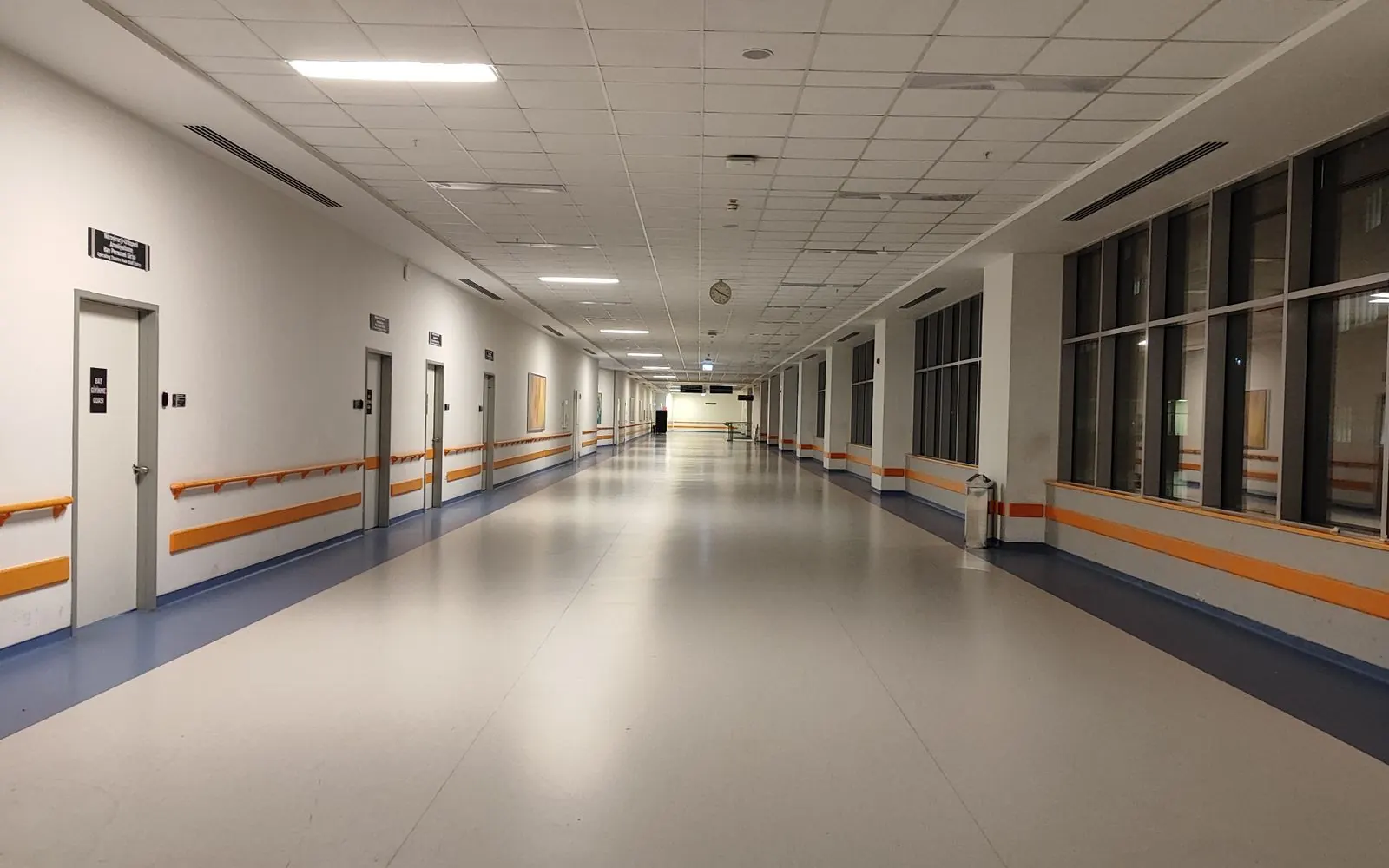 Empty, well-lit corridor of a modern hospital
